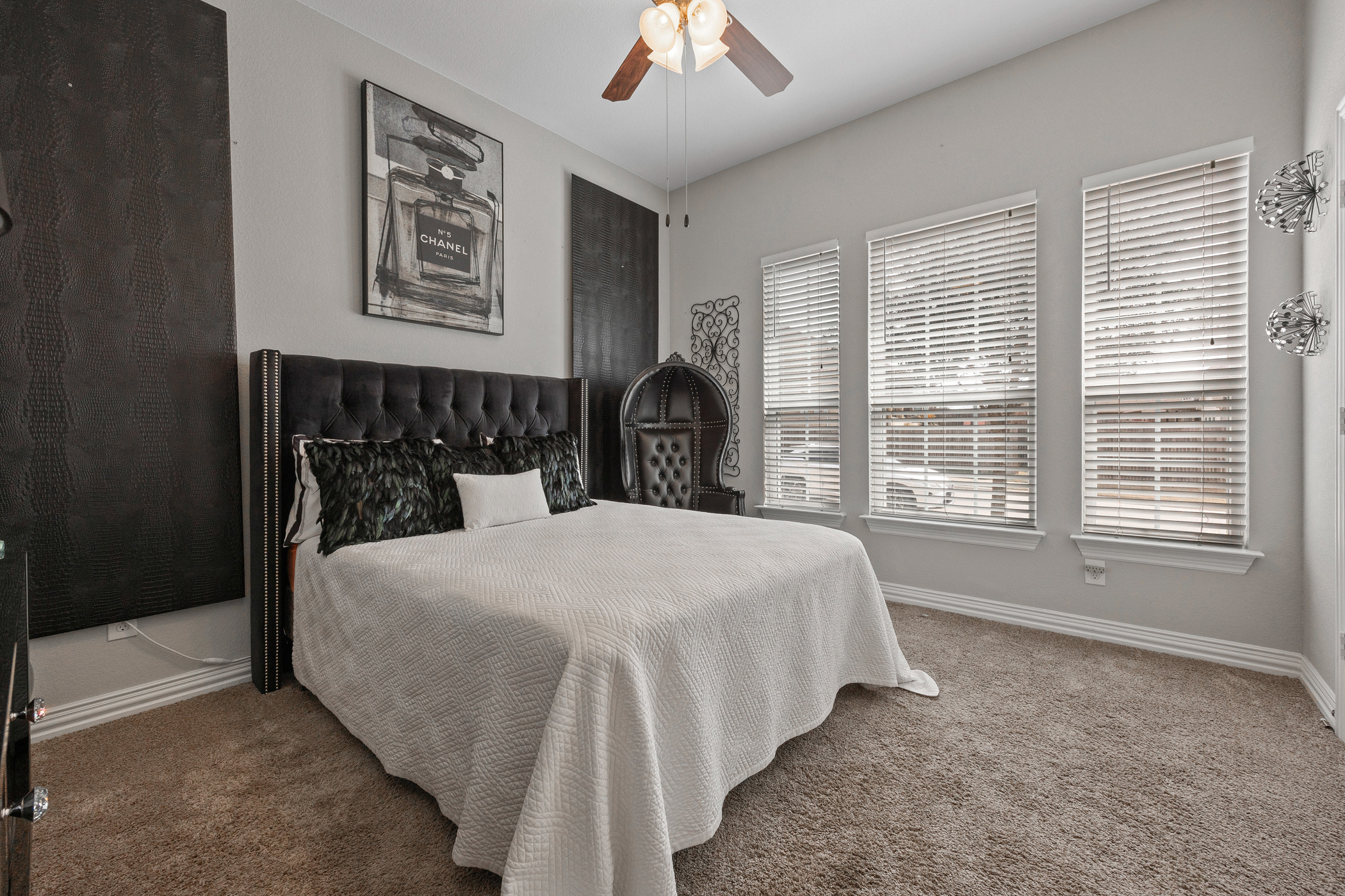 381 Betony Loop Buda, TX 78610 - Photo 14 of 32 a bedroom with a bed and a chandelier