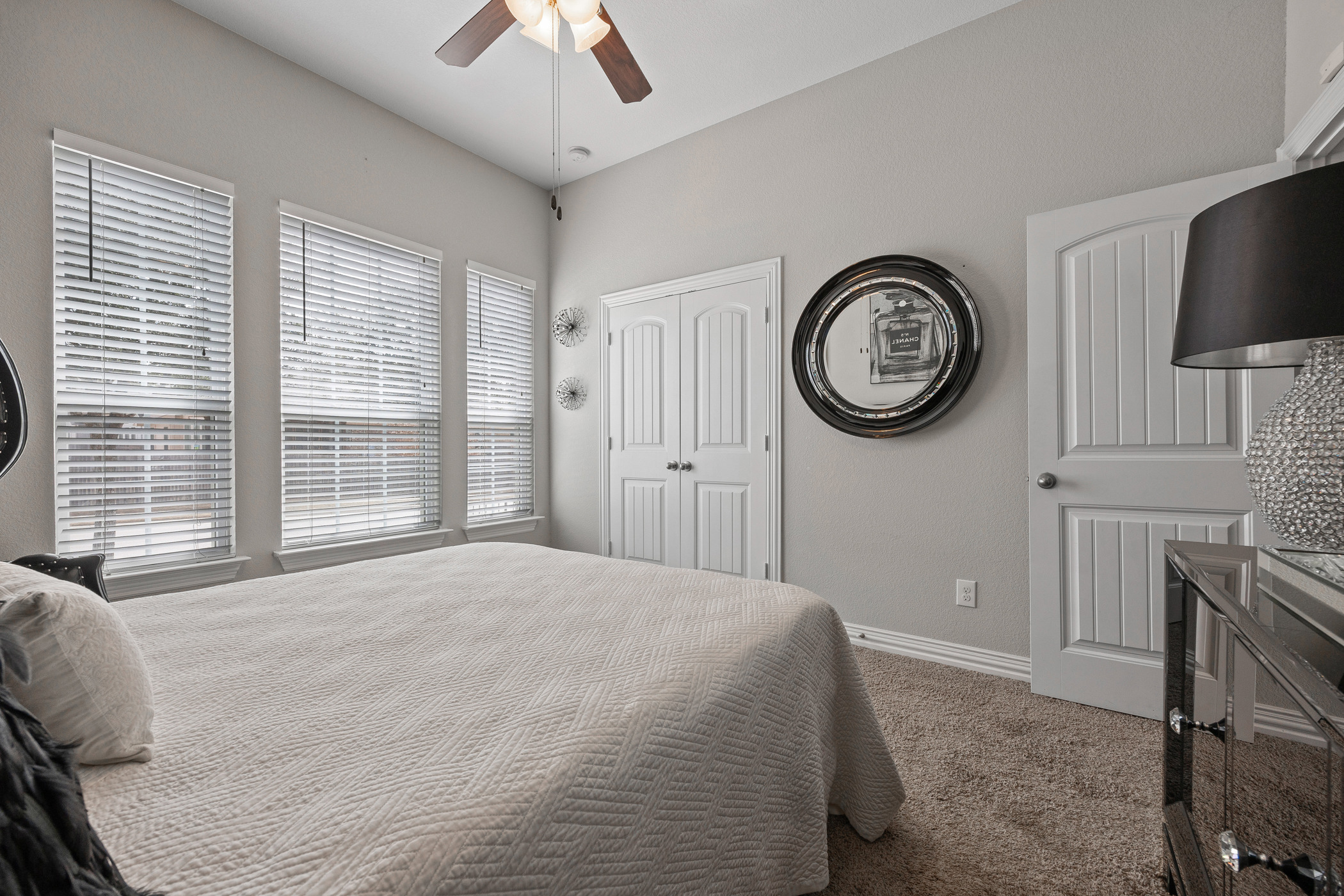 381 Betony Loop Buda, TX 78610 - Photo 15 of 32 a bedroom with a bed and a chandelier