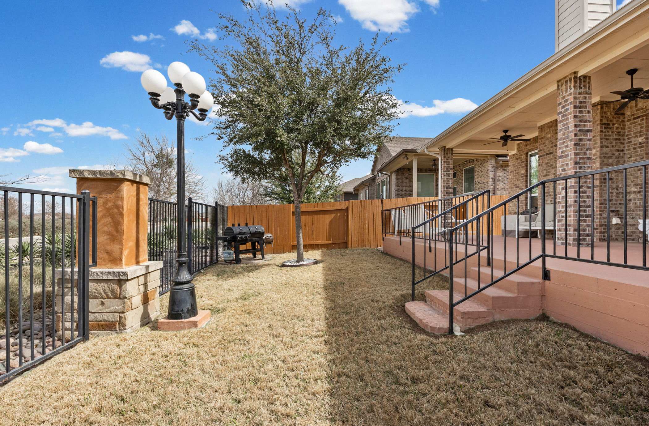 381 Betony Loop Buda, TX 78610 - Photo 18 of 32 a view of a house with wooden fence