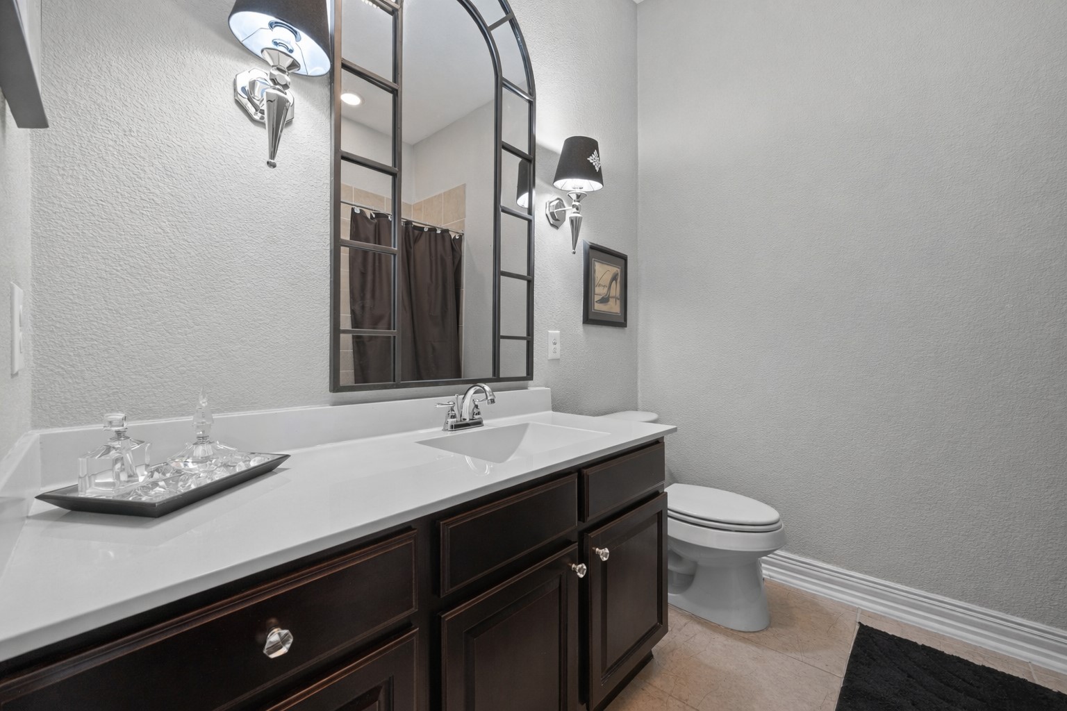 381 Betony Loop Buda, TX 78610 - Photo 21 of 32 a bathroom with a granite countertop sink a toilet and a mirror
