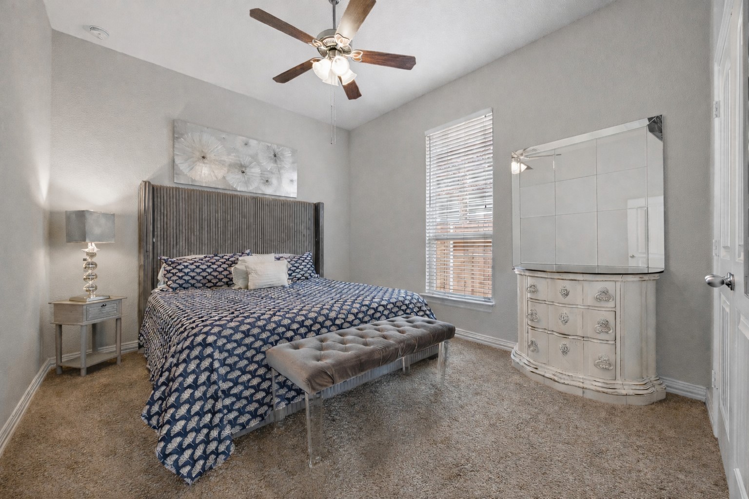 381 Betony Loop Buda, TX 78610 - Photo 25 of 32 a bedroom with a bed and a chandelier