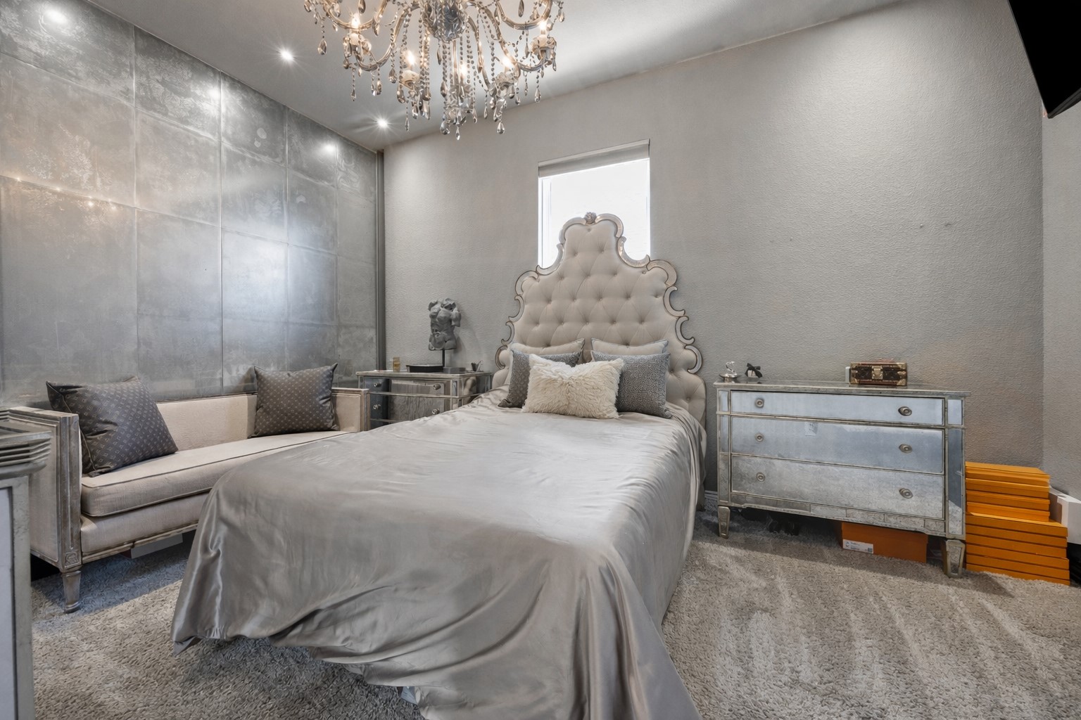 381 Betony Loop Buda, TX 78610 - Photo 26 of 32 a bedroom with a bed and a chandelier