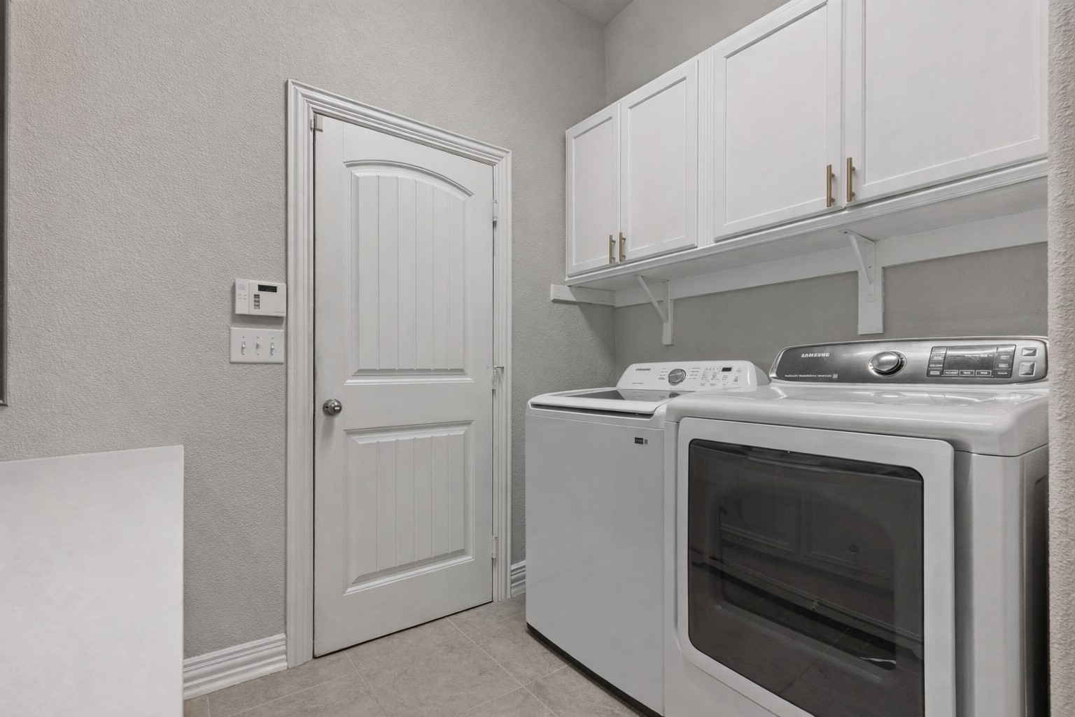 381 Betony Loop Buda, TX 78610 - Photo 27 of 32 a utility room with dryer and washer