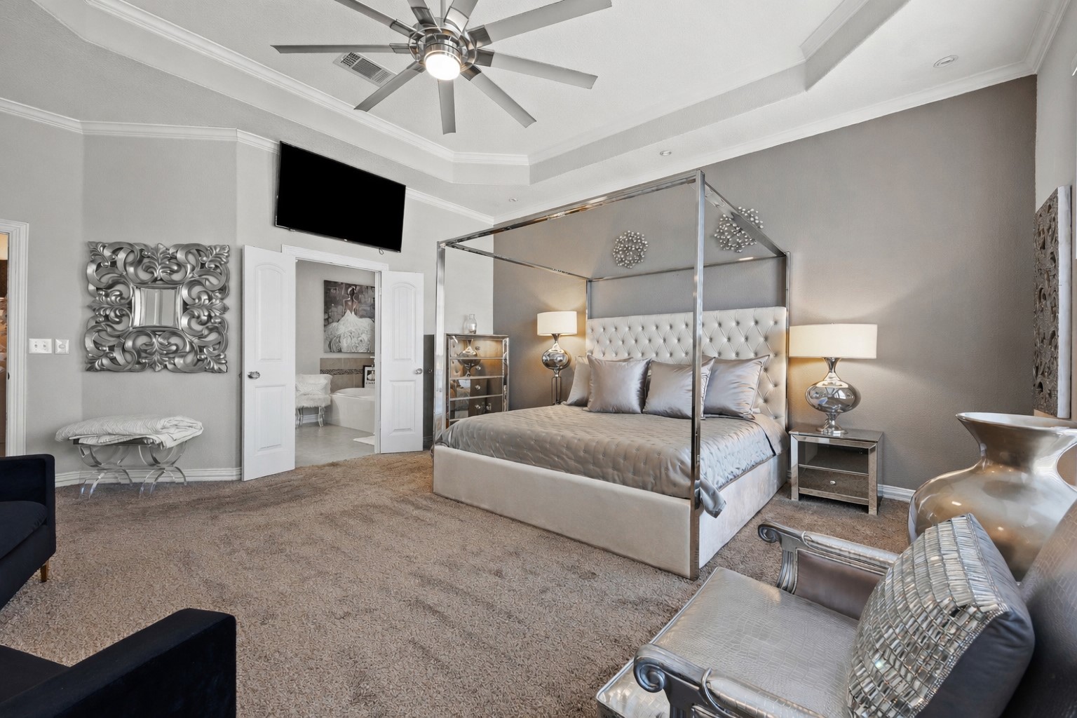 381 Betony Loop Buda, TX 78610 - Photo 28 of 32 a bedroom with a bed flat screen tv and couches