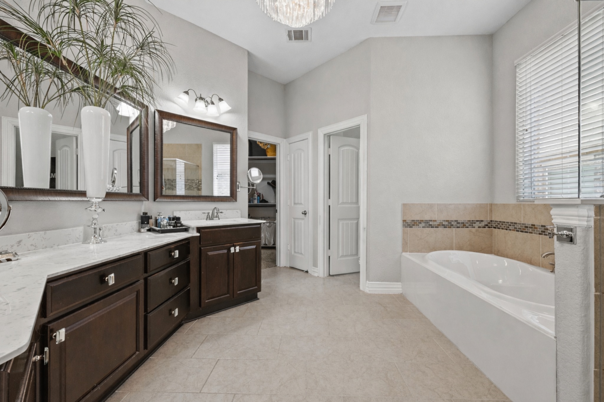 381 Betony Loop Buda, TX 78610 - Photo 32 of 32 a spacious bathroom with a tub sink and mirror
