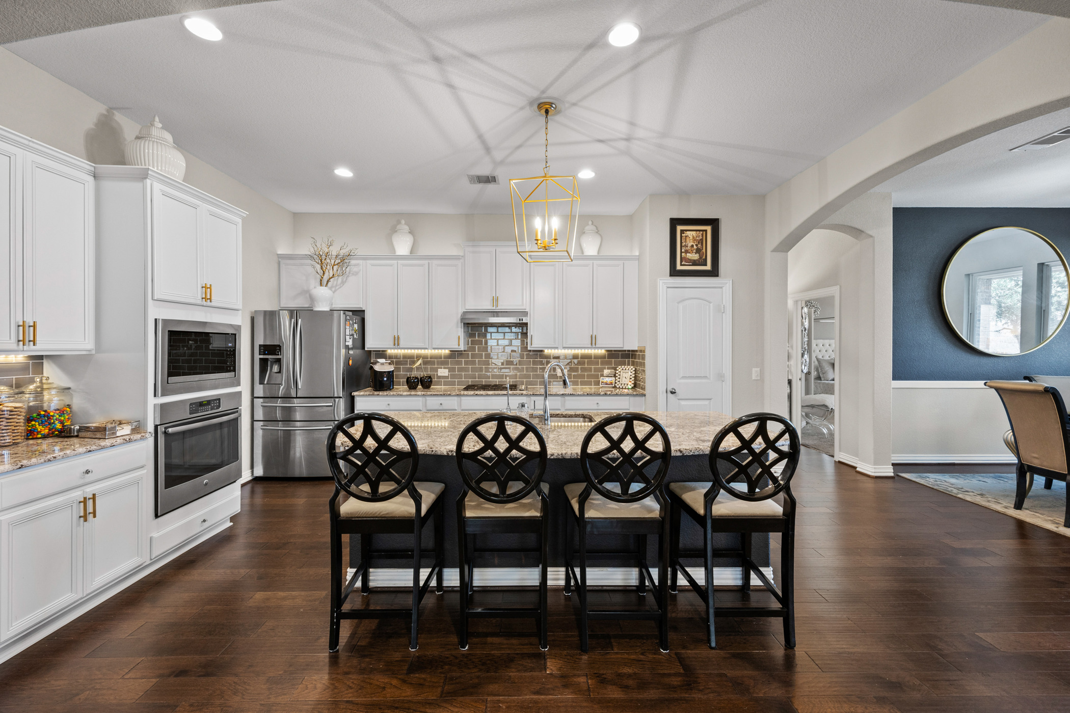 381 Betony Loop Buda, TX 78610 - Photo 4 of 32 a large kitchen with a table and chairs