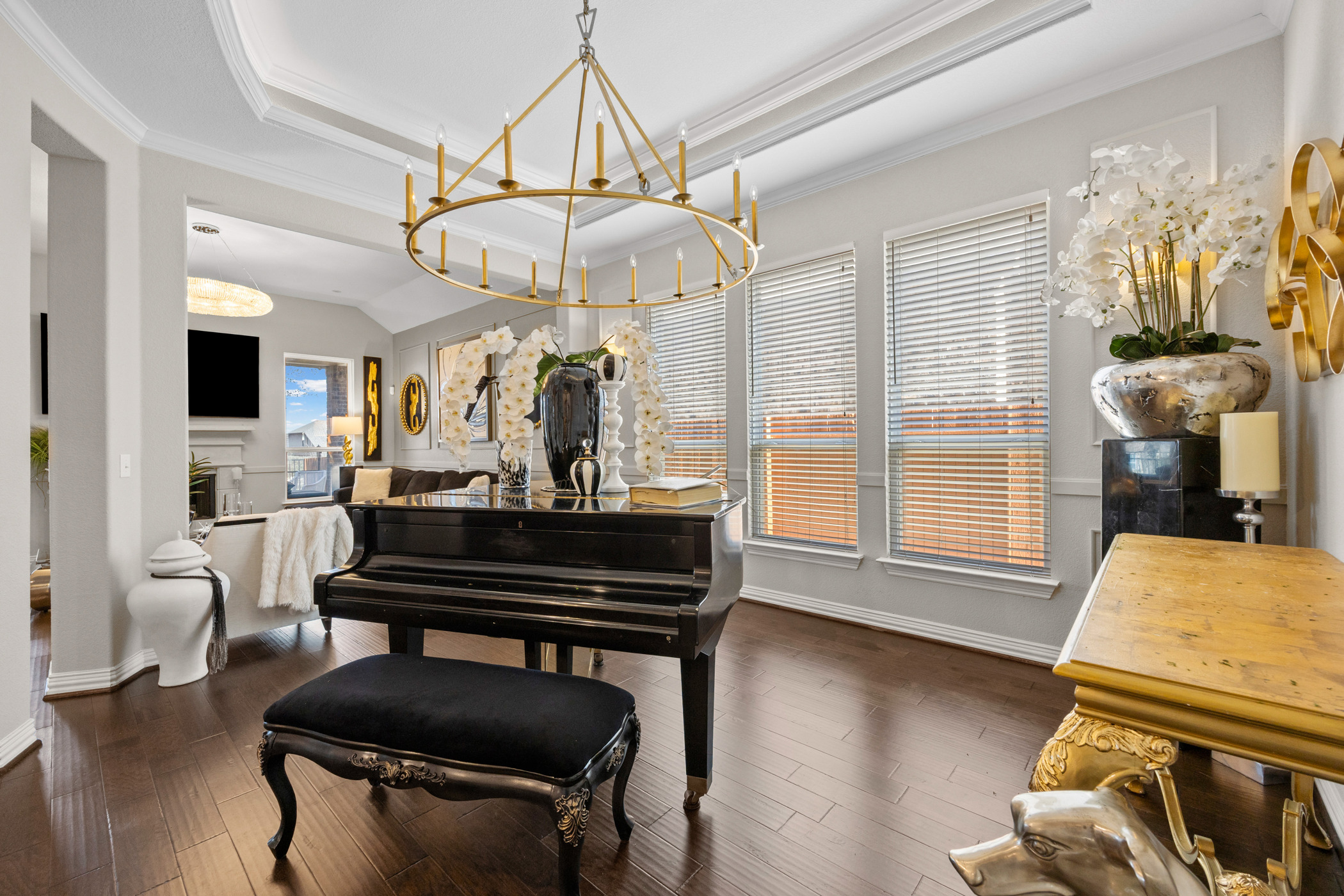 381 Betony Loop Buda, TX 78610 - Photo 7 of 32 a living room with furniture a dining table and a chandelier