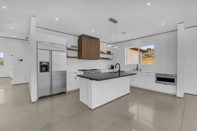 a kitchen with stainless steel appliances a sink stove and refrigerator