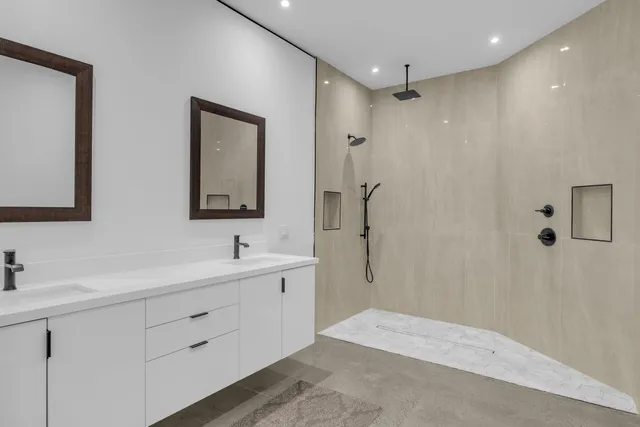 a bathroom with double sink a two mirror and a