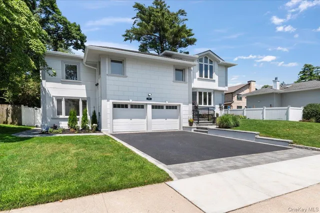 a front view of a house with a garden