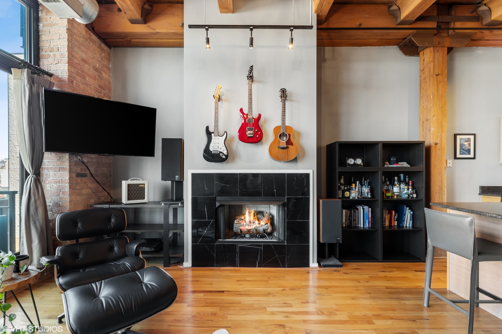 1250 West Van Buren Street, Unit 605 Chicago, IL 60607 - Photo 4 of 16 a living room with furniture and a fireplace