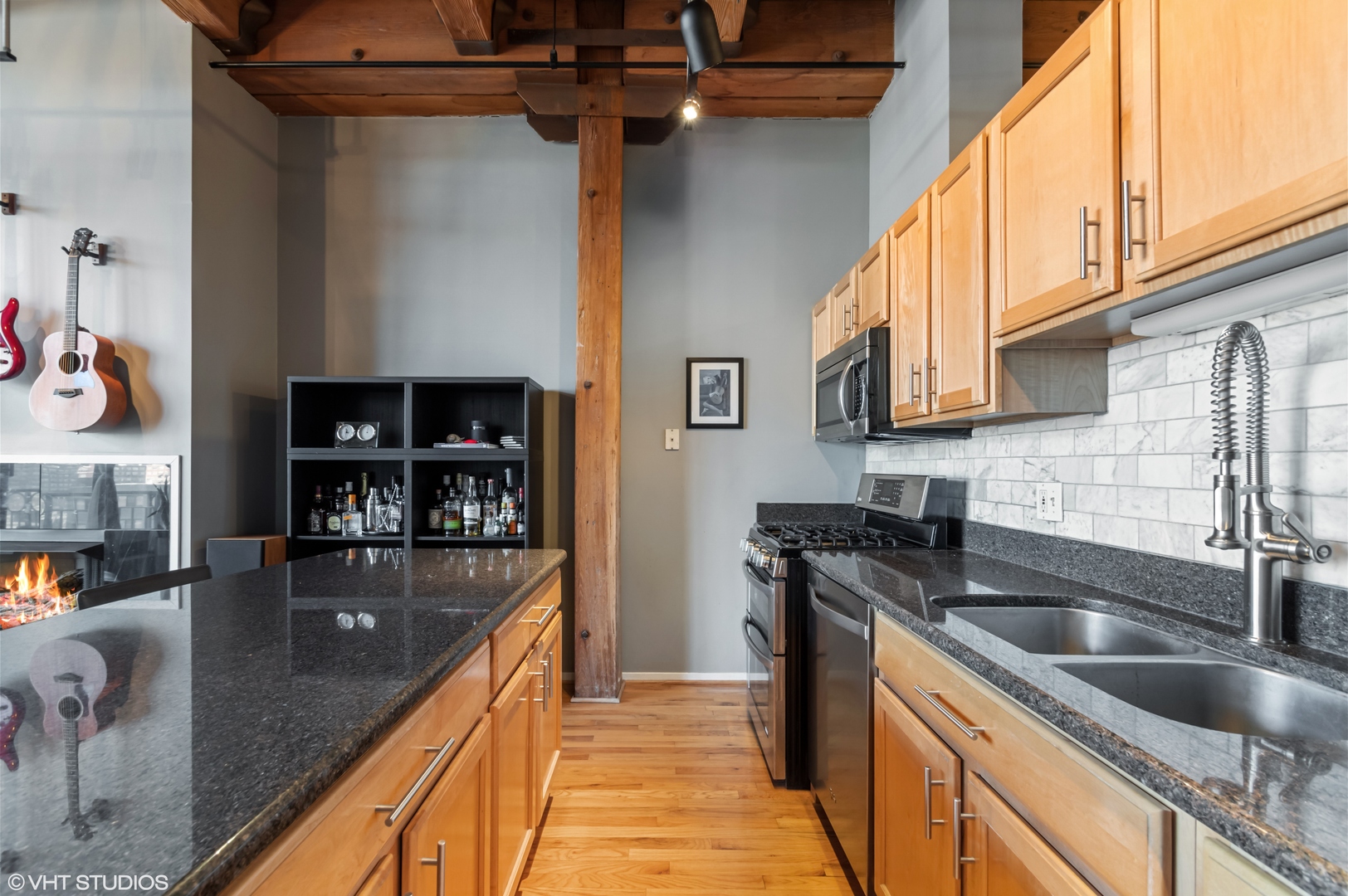 1250 West Van Buren Street, Unit 605 Chicago, IL 60607 - Photo 8 of 16 a kitchen with stainless steel appliances granite countertop a sink a stove and a wooden cabinets