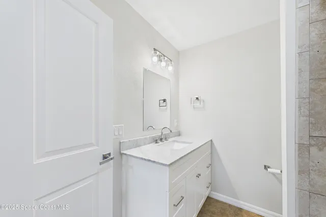 a view of a room with wooden floor and a ceiling fan