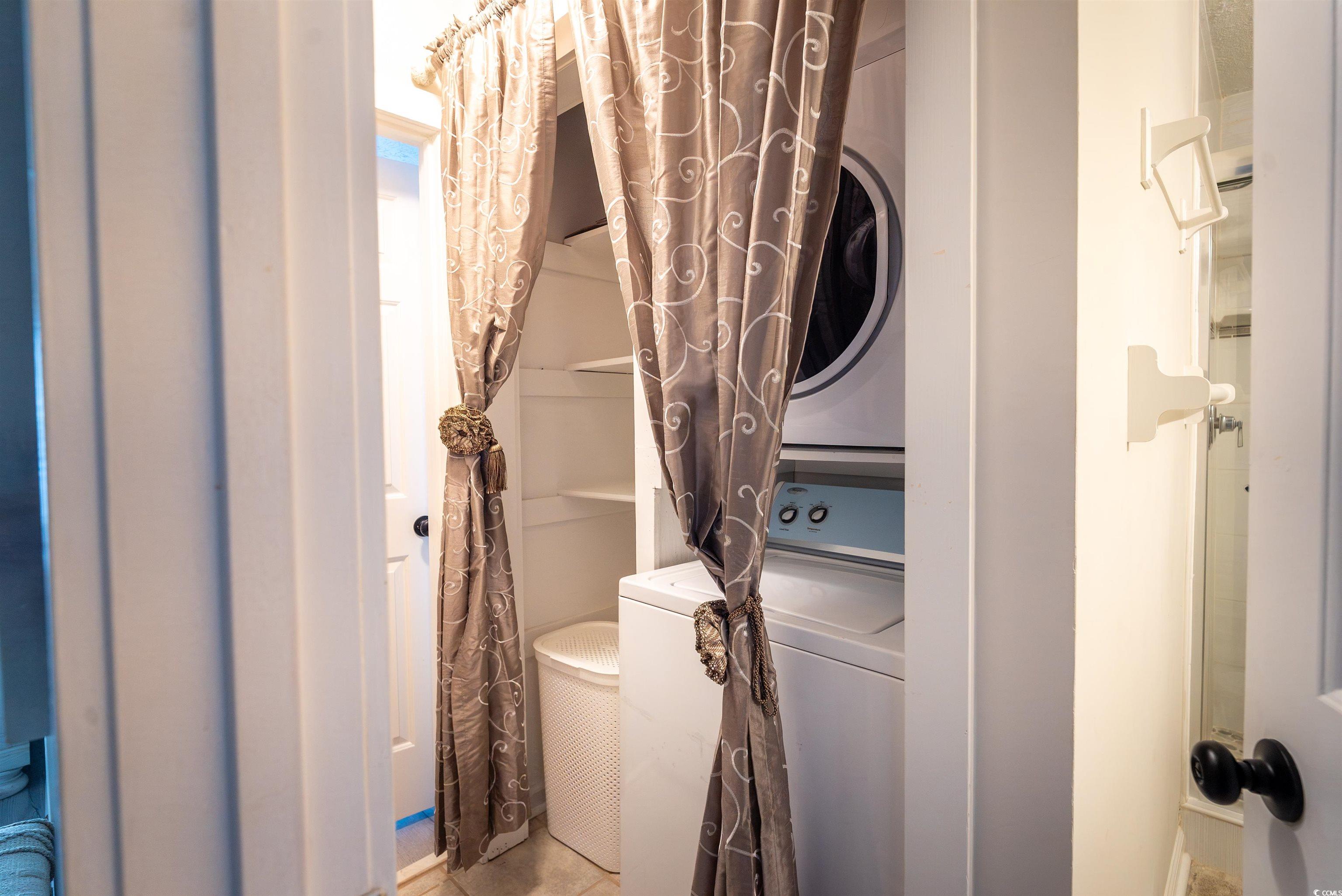 4715 Cobblestone Drive Myrtle Beach, SC 29577 - Photo 11 of 12 Laundry area featuring stacked washer / dryer and light tile patterned flooring