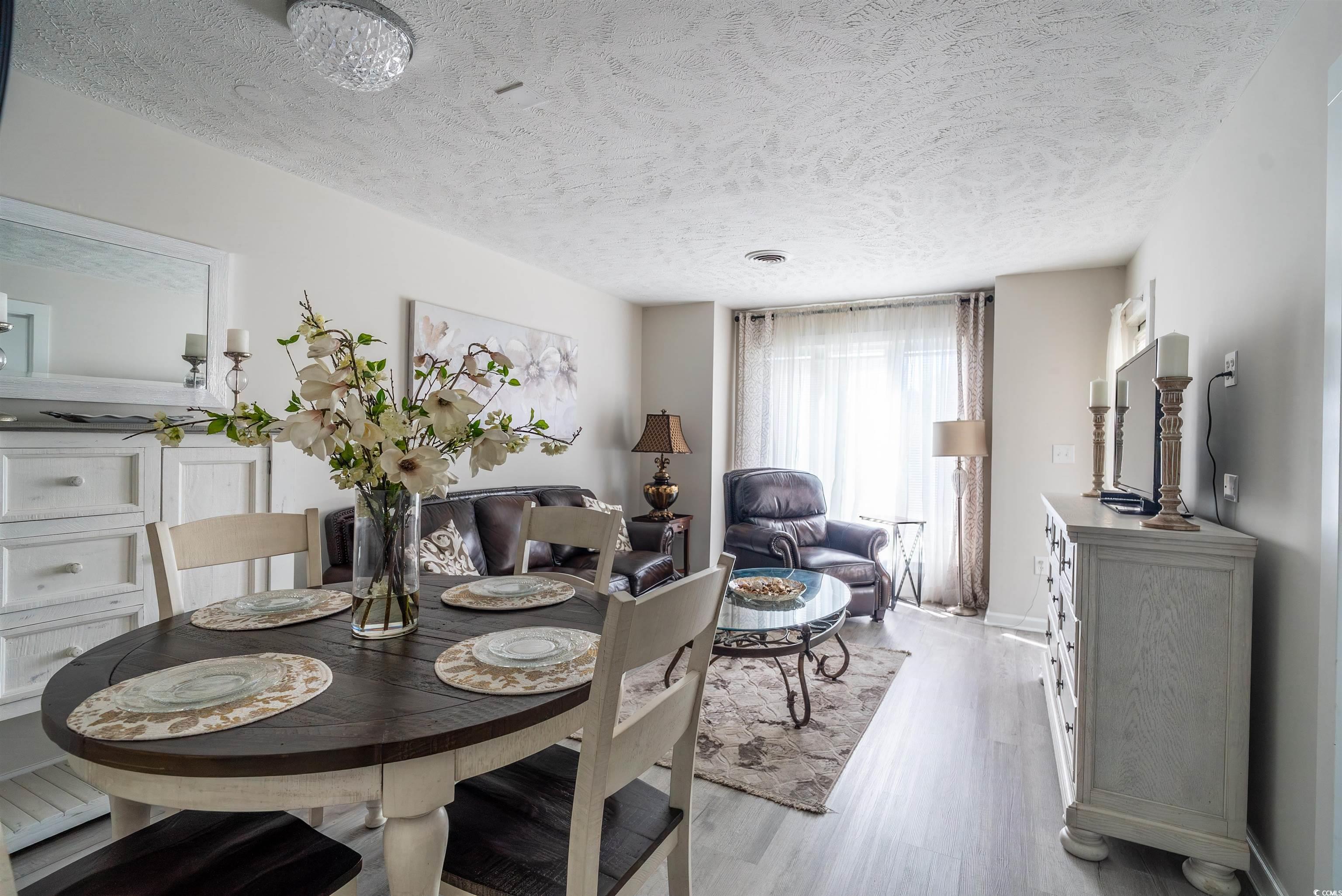 4715 Cobblestone Drive Myrtle Beach, SC 29577 - Photo 6 of 12 Dining space with a textured ceiling and wood finished floors