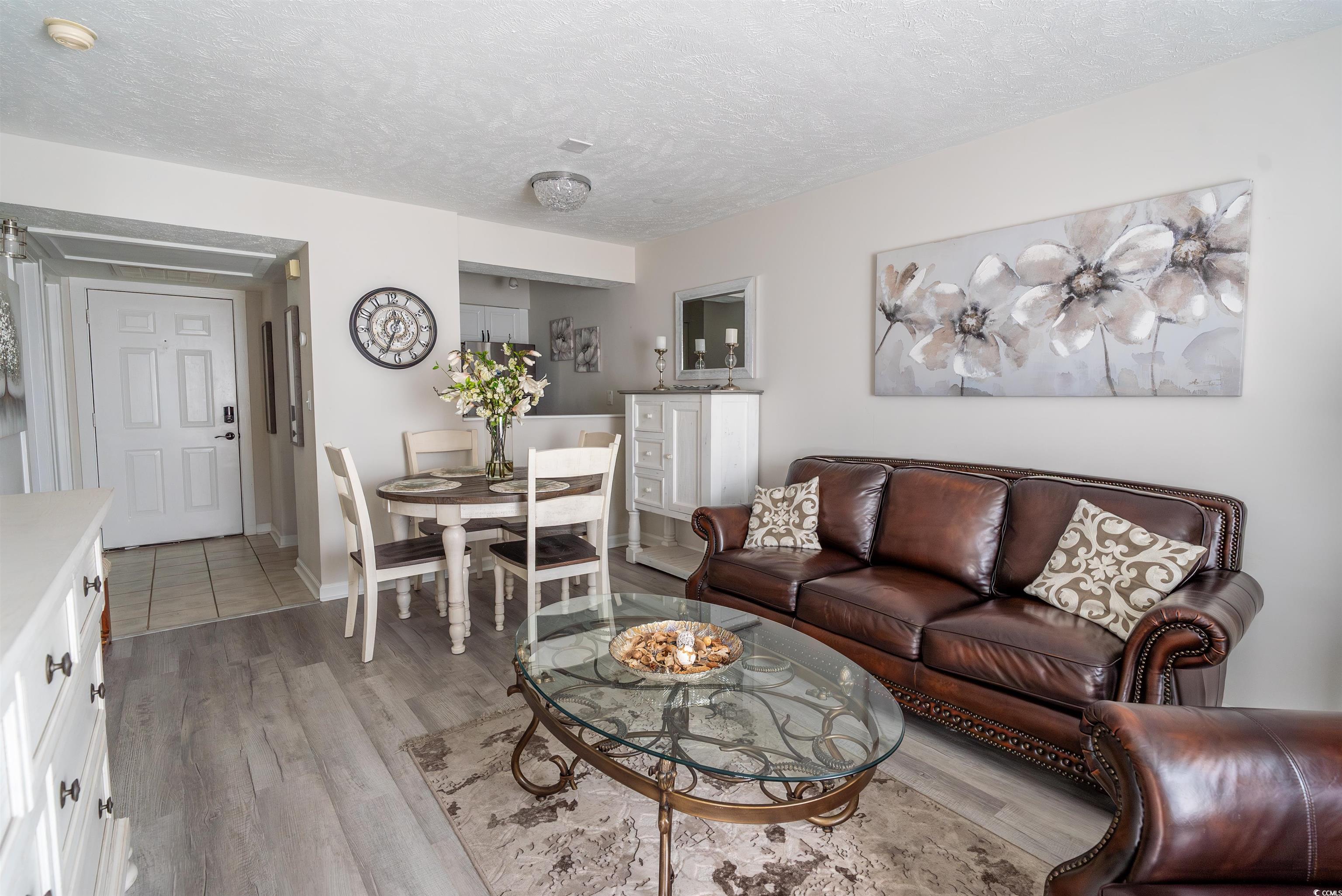 4715 Cobblestone Drive Myrtle Beach, SC 29577 - Photo 7 of 12 Living room featuring a textured ceiling and light wood-style flooring