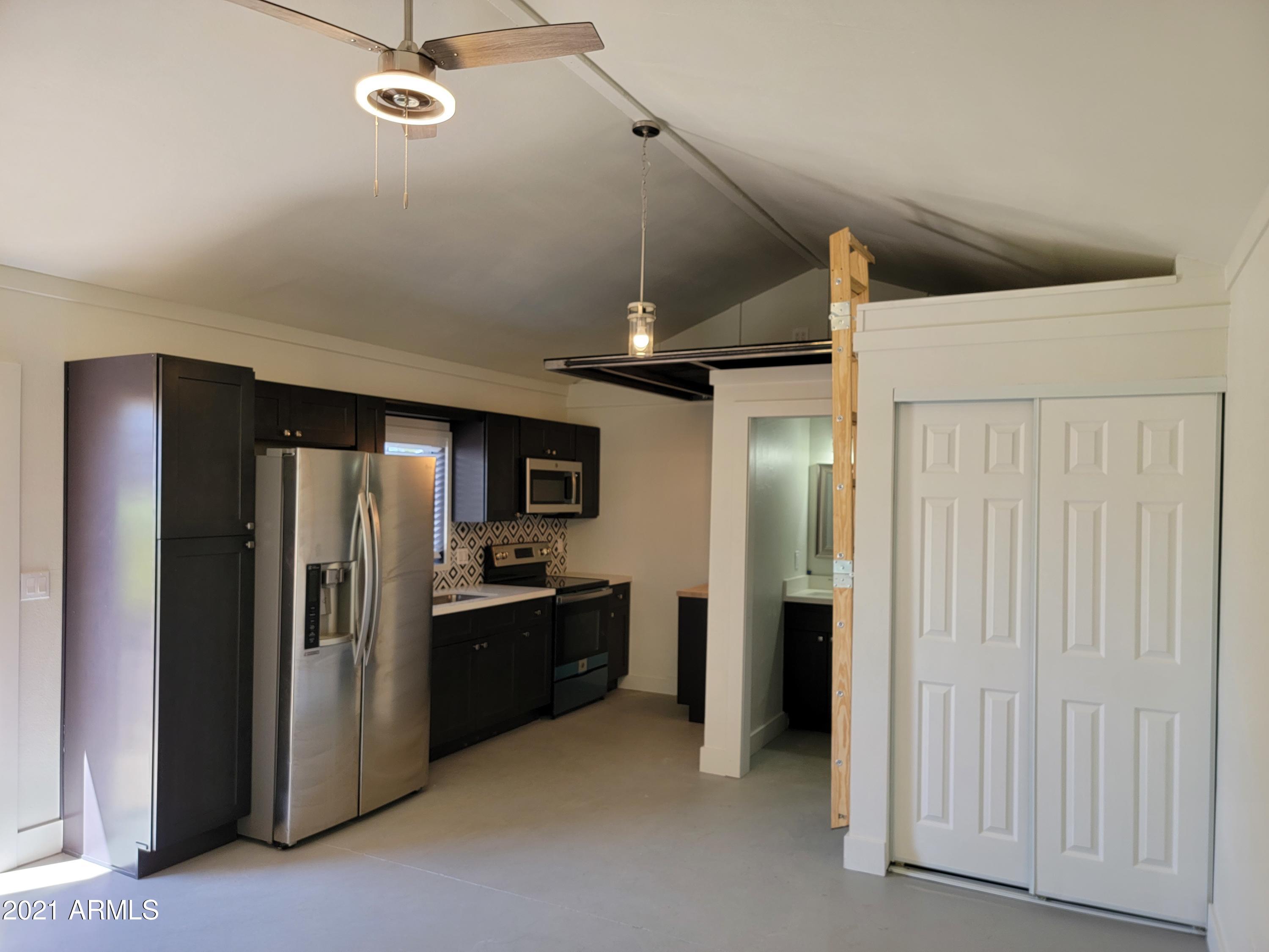 1638 East Granada Road, Unit B Phoenix, AZ 85006 - Photo 2 of 19 an empty room with stainless steel appliances kitchen island a refrigerator and a stove