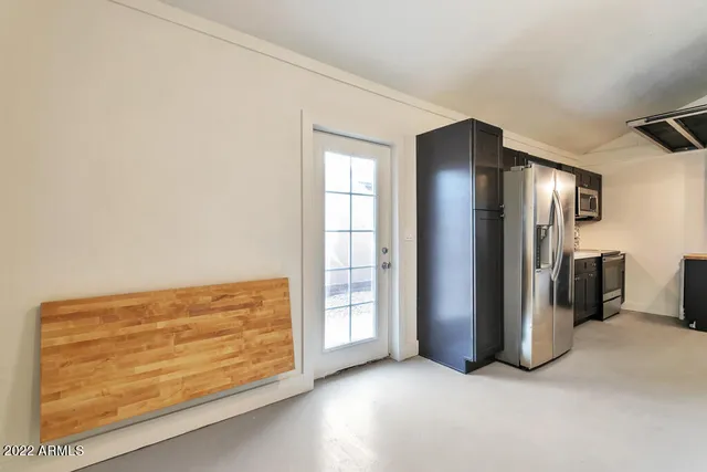 an empty room with closet and windows