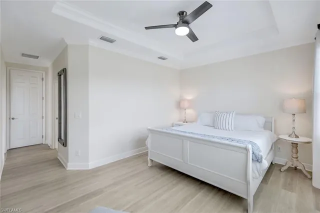 a bedroom with a bed and a ceiling fan