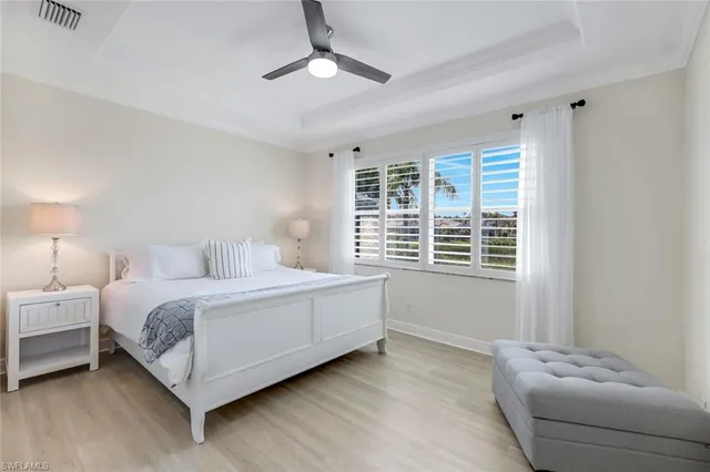 a spacious bedroom with a bed and a couch