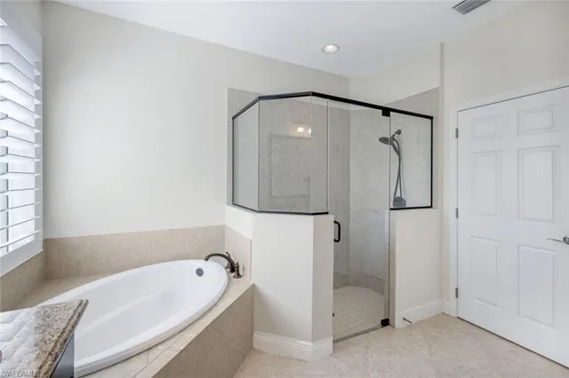 a bathroom with a tub and a shower