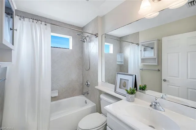 a bathroom with a sink toilet tub and shower
