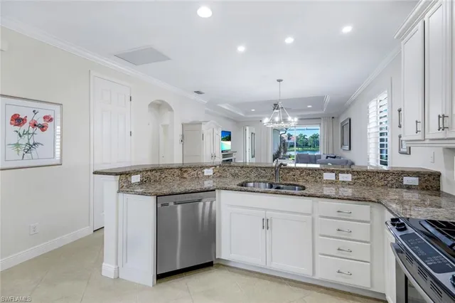 a kitchen with granite countertop white cabinets and white appliances