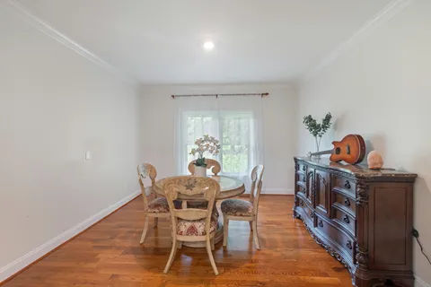 a dining room with furniture and wooden floor