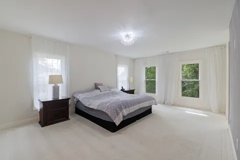 a spacious bathroom with a tub sink and mirror