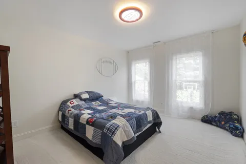 a bathroom with double sink and a mirror