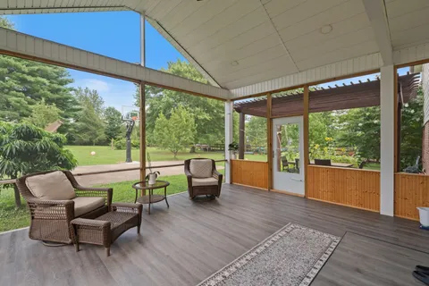 a view of a patio with table and chairs potted plants with wooden floor