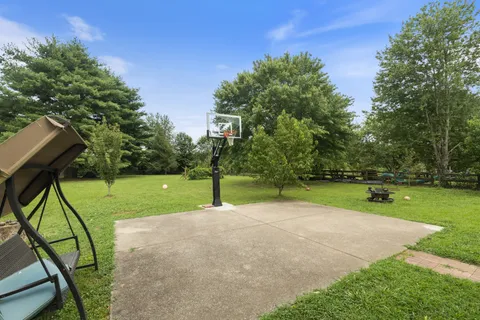 an aerial view of a houses with a lush green hillside