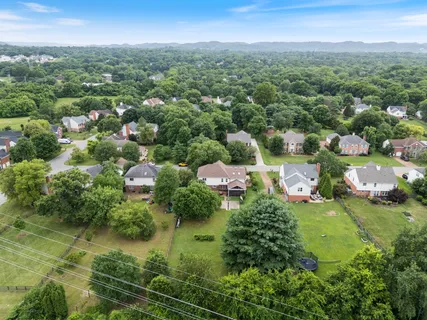 a view of a house with a yard and a garage