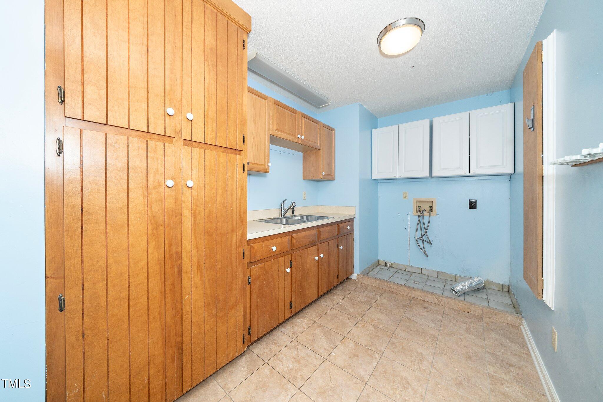 10213 Jordan Road Raleigh, NC 27603 - Photo 29 of 62 a kitchen with a refrigerator and white cabinets