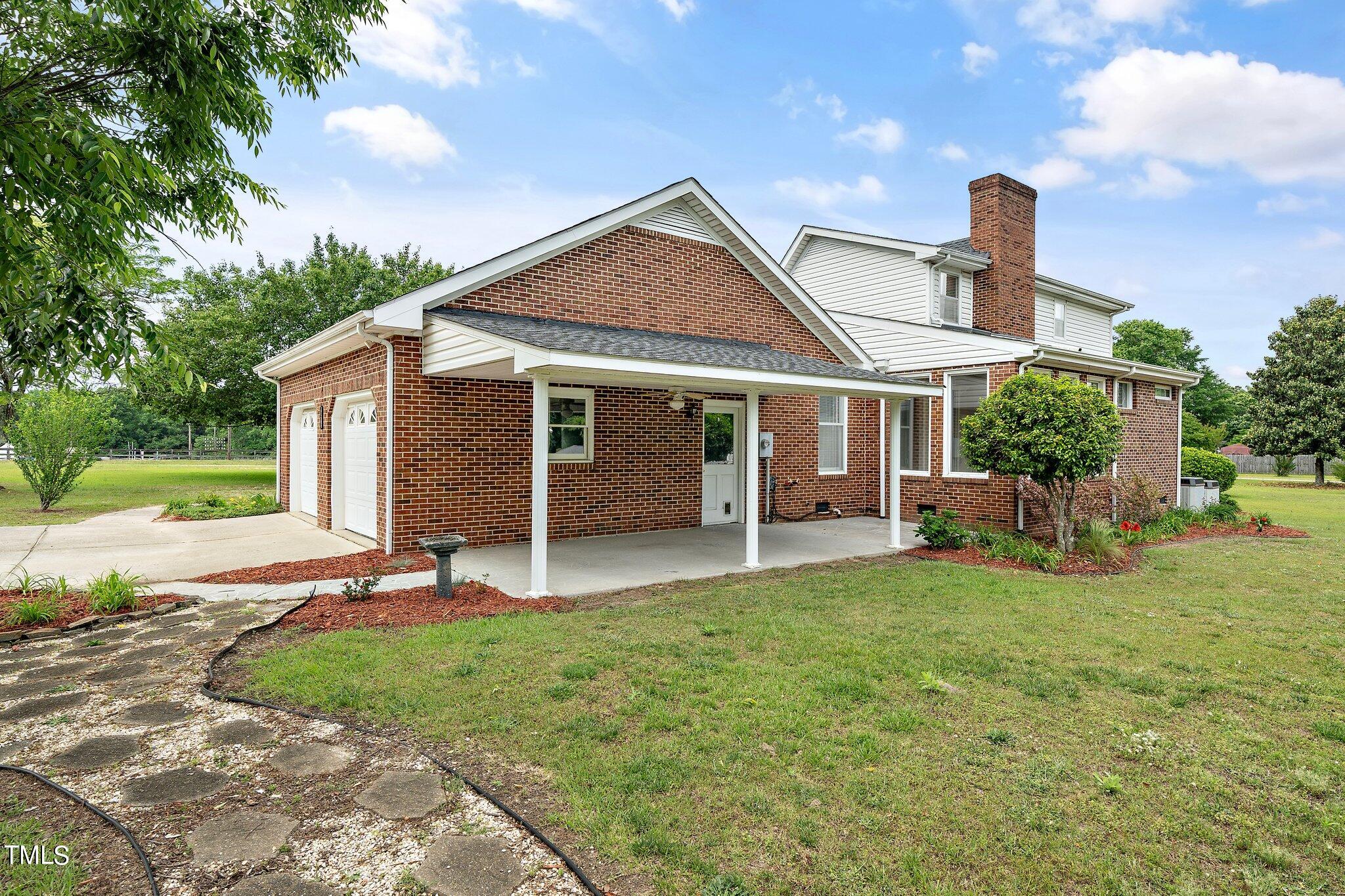 10213 Jordan Road Raleigh, NC 27603 - Photo 45 of 62 a front view of a house with a yard and porch