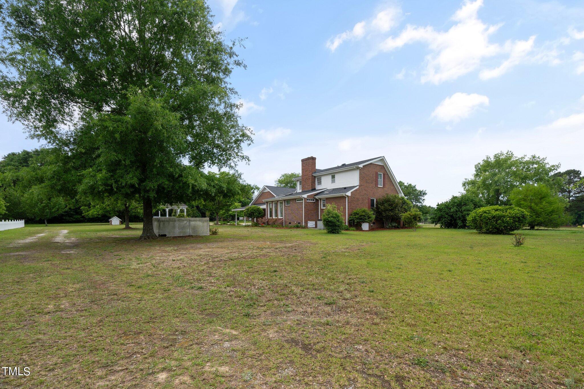 10213 Jordan Road Raleigh, NC 27603 - Photo 47 of 62 a front view of a house with a yard and trees