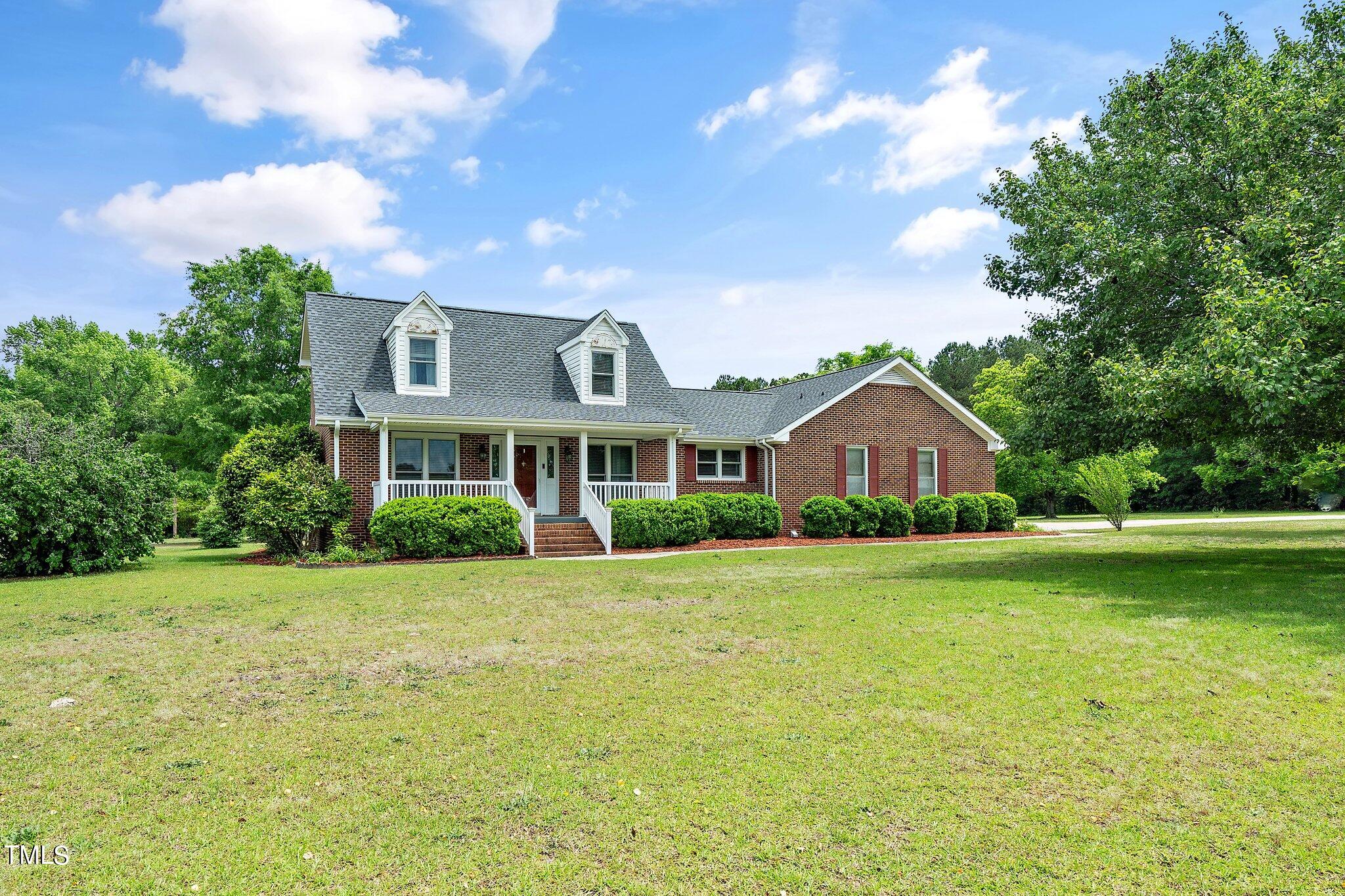 10213 Jordan Road Raleigh, NC 27603 - Photo 6 of 62 a front view of a house with garden