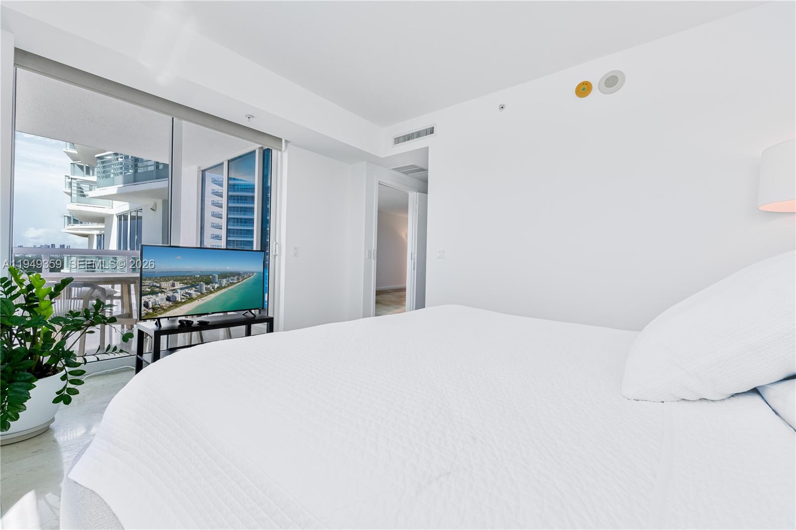 3801 Collins Avenue, Unit 1105 Miami Beach, FL 33140 - Photo 13 of 44 a room with a bed and a chair