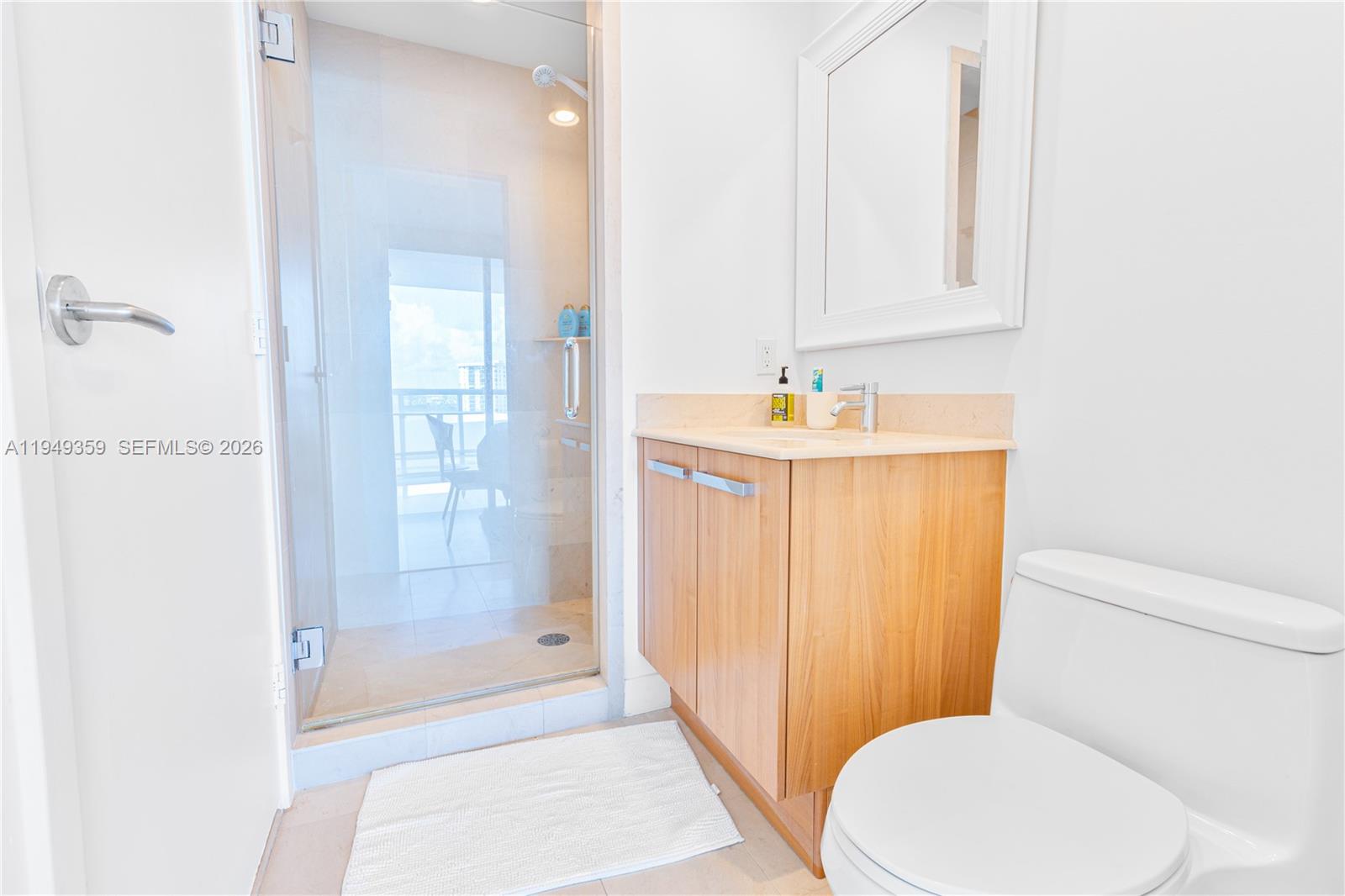 3801 Collins Avenue, Unit 1105 Miami Beach, FL 33140 - Photo 28 of 44 a bathroom with a sink a toilet and shower