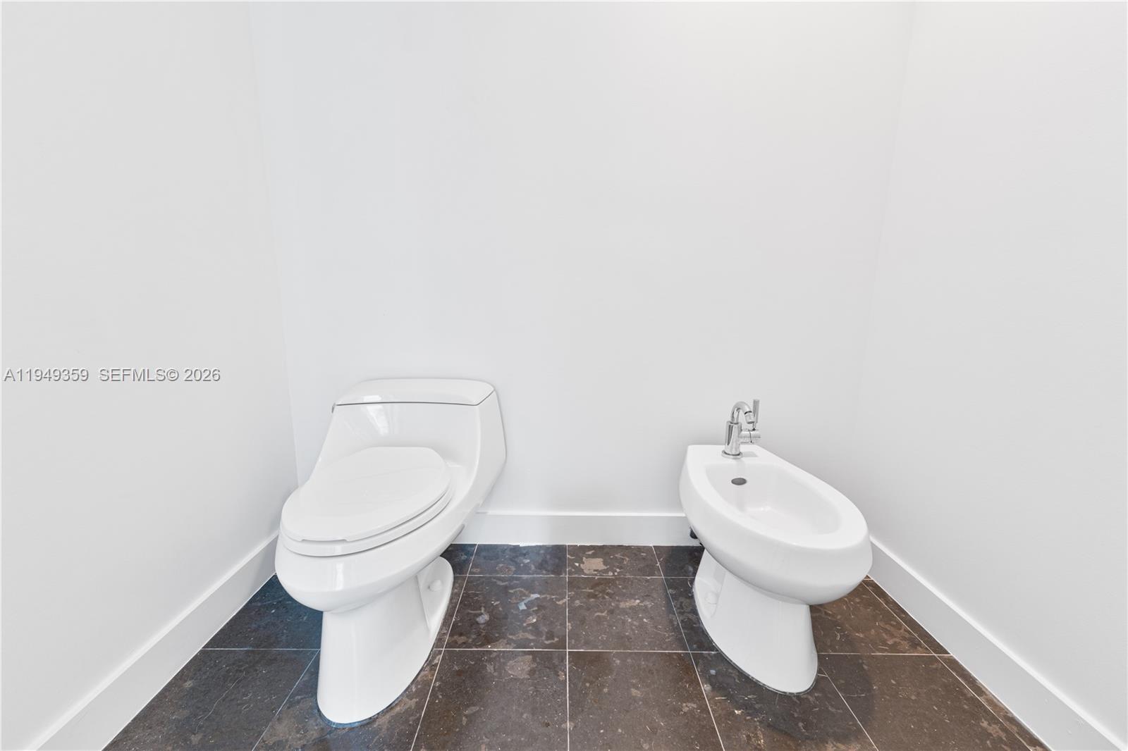 3801 Collins Avenue, Unit 1105 Miami Beach, FL 33140 - Photo 31 of 44 a white toilet sitting next to a white sink