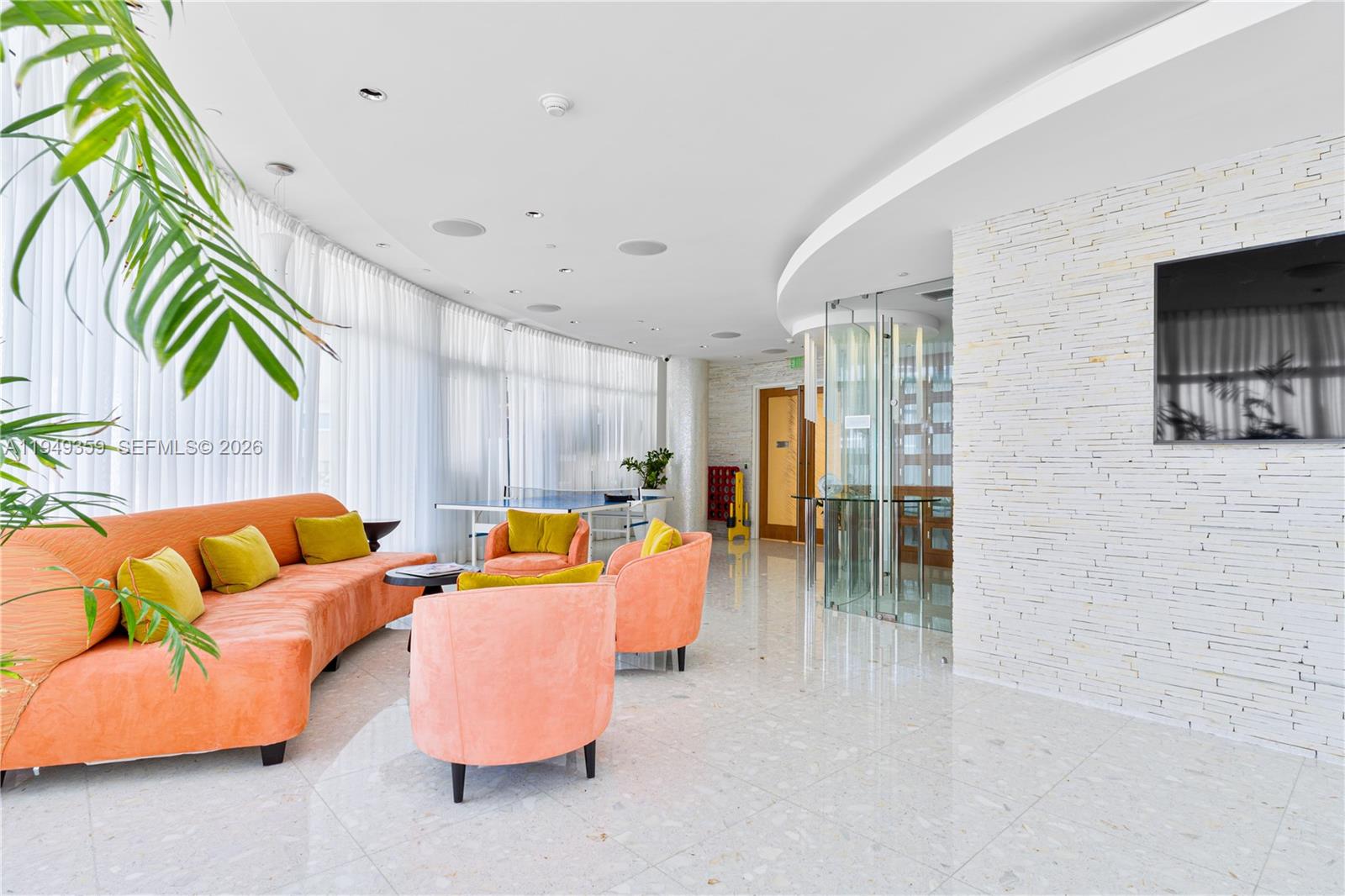 3801 Collins Avenue, Unit 1105 Miami Beach, FL 33140 - Photo 35 of 44 a living room with furniture and a flat screen tv