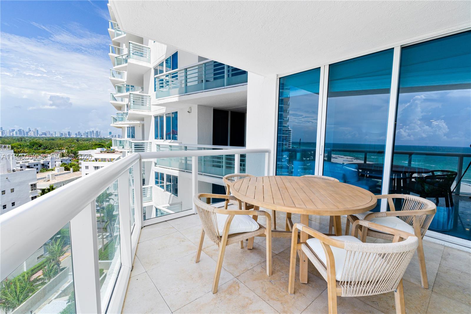 3801 Collins Avenue, Unit 1105 Miami Beach, FL 33140 - Photo 10 of 44 a patio with a table and chairs