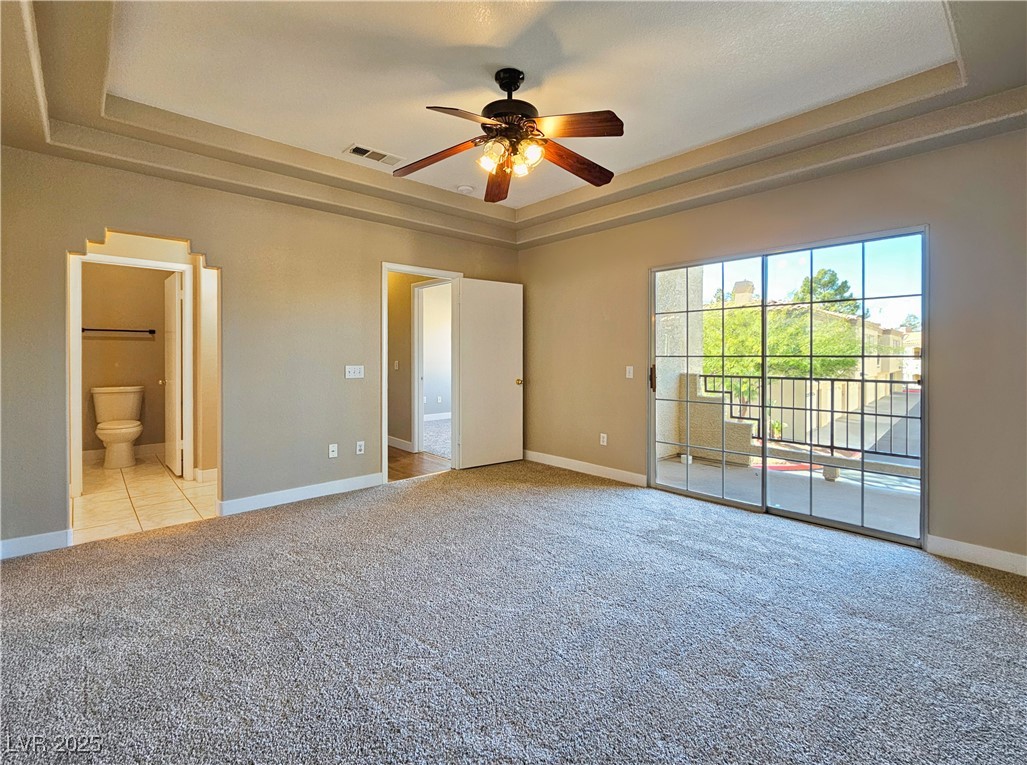 1851 Hillpointe Road, Unit 2124 Henderson, NV 89074 - Photo 14 of 24 Unfurnished bedroom with carpet flooring, visible vents, baseboards, a raised ceiling, and access to outside