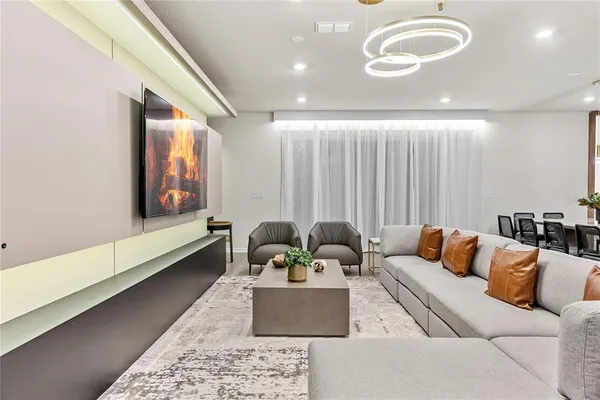 a kitchen with stainless steel appliances a sink a stove a microwave a refrigerator and cabinets