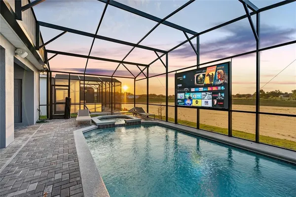 a kitchen with granite countertop a stove a sink and a refrigerator