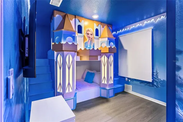 a bedroom with a large bed and a chandelier