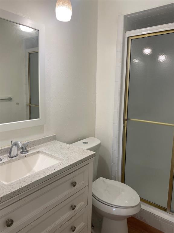1109 Cross Bend Road Plano, TX 75023 - Photo 10 of 11 Vanity featuring a white countertop with integrated sink and chrome faucet