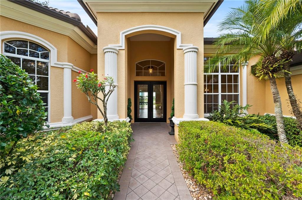 527 Terracina Way Naples, FL 34119 - Photo 11 of 48 a front view of a house with garden