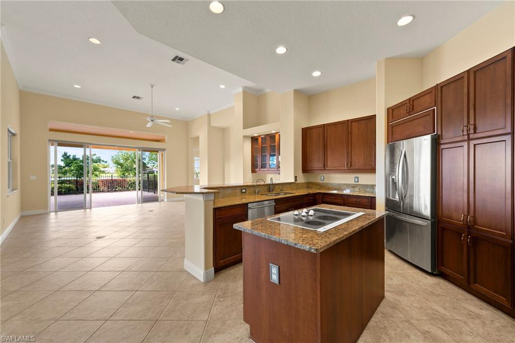 527 Terracina Way Naples, FL 34119 - Photo 20 of 48 a kitchen that has a sink stainless steel appliances a counter space and a window