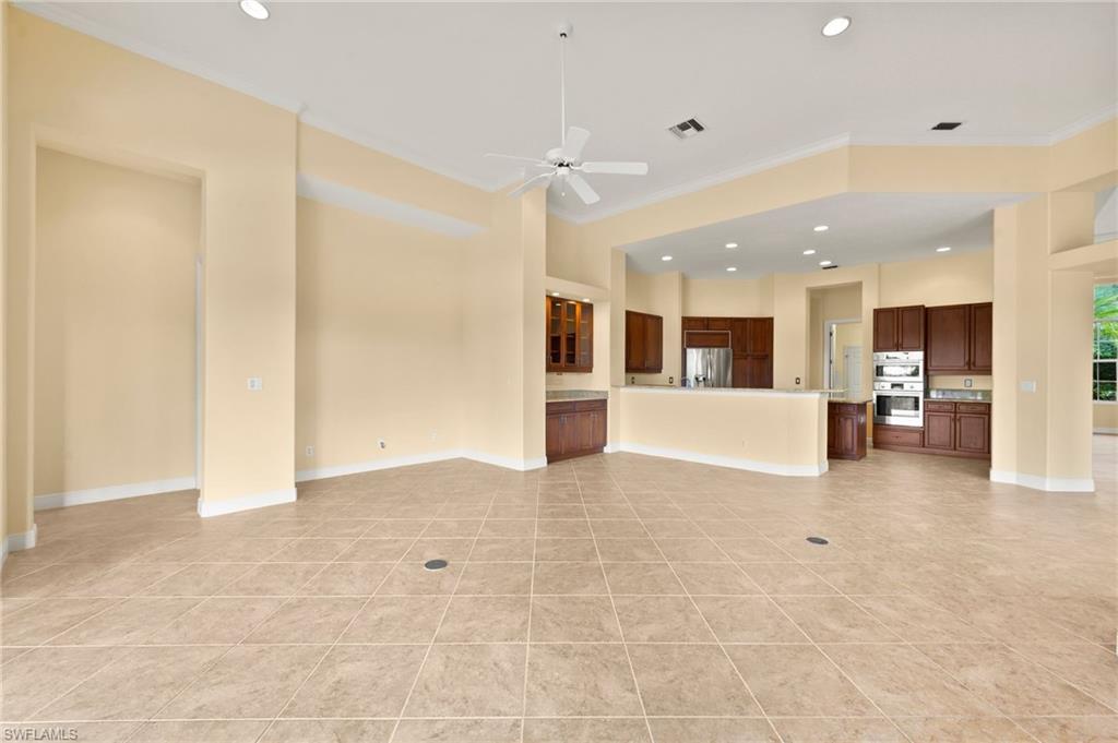 527 Terracina Way Naples, FL 34119 - Photo 24 of 48 a view of a big room with kitchen and windows